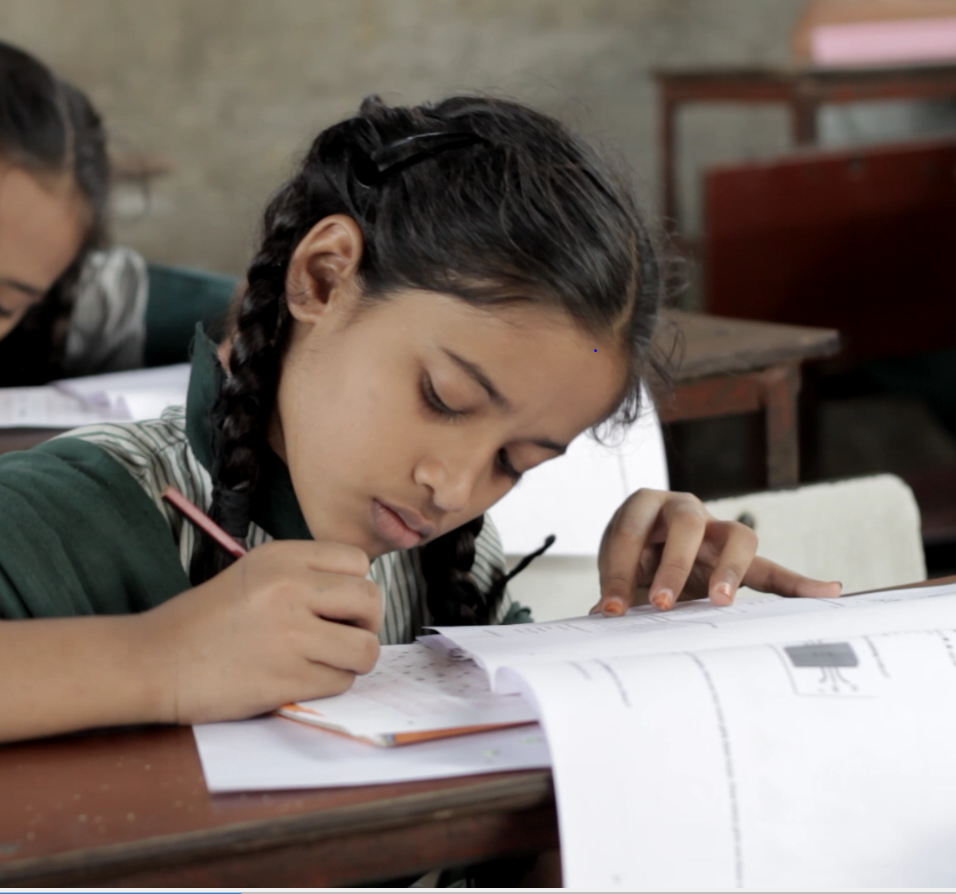 Student writing in a classroom during a VVK Education Foundation school improvement program in Maharashtra